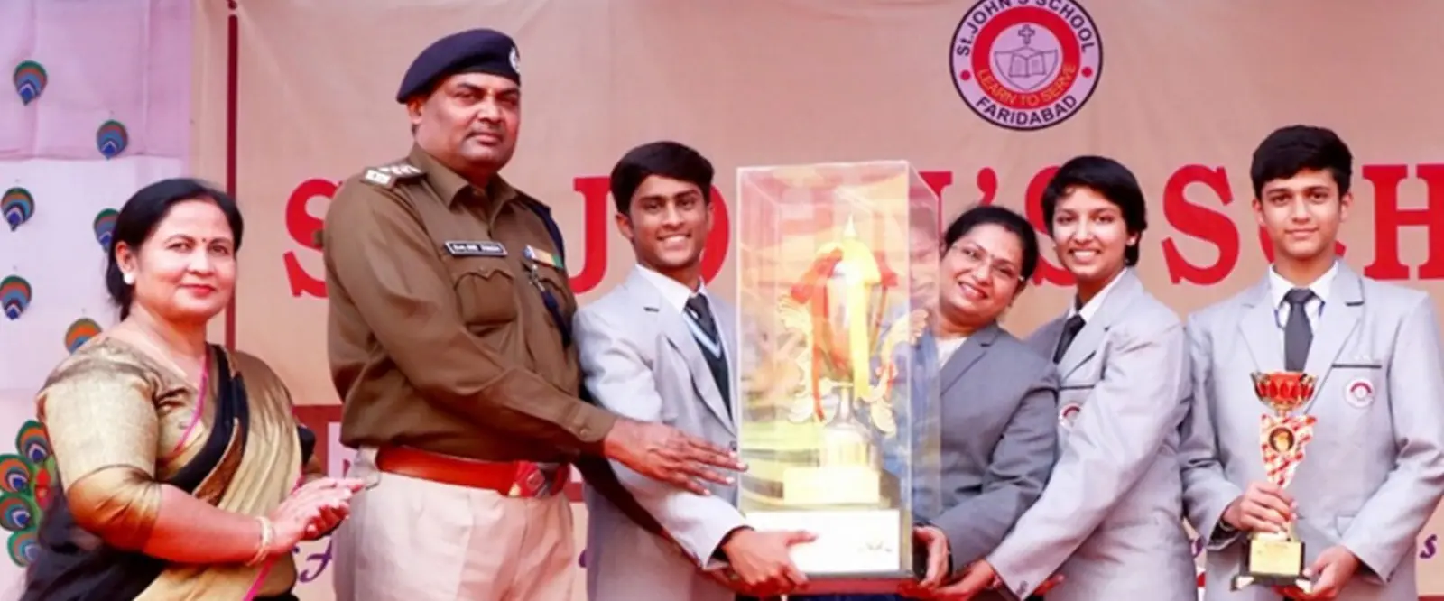Students receiving a trophy